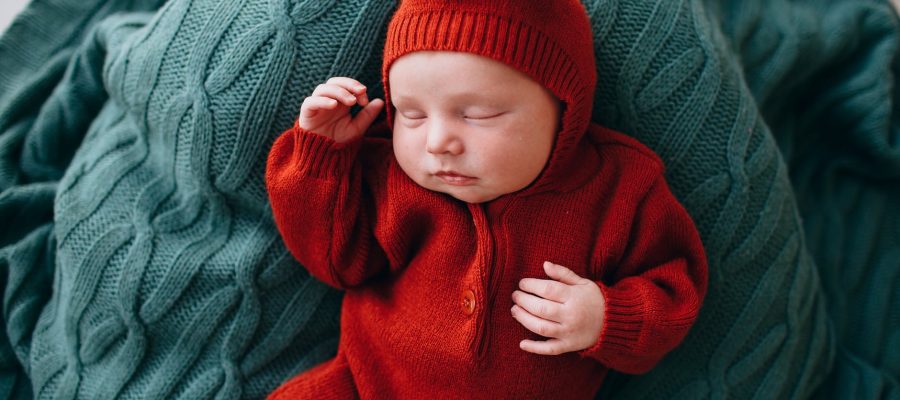 small cute baby with gentle little hands sleeping on blanket